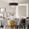 grey-and-yellow-chair-at-table-under-lamp-in-dining-room-interior-with-posters-and-plants-real-photo