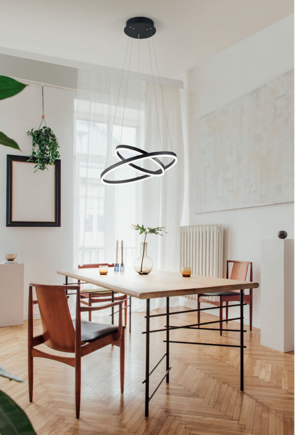 stylish-and-modern-dining-room-interior-with-design-sharing-table-chairs-gold-pedant-lamp-abstract-paintings-and-elegant-accessories-tropical-leafs-in-vase-eclectic-decor-brown-wooden-parquet